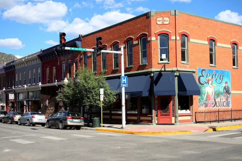 Historic brick corner building with Salida mural
