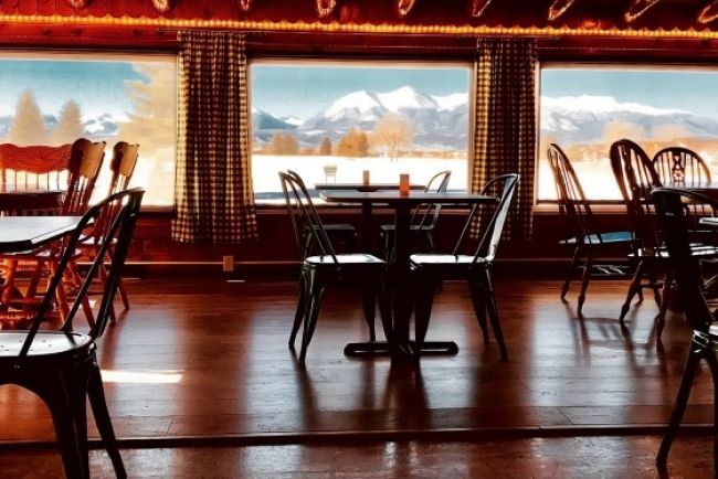 Cozy cabin dining with snowy mountain view