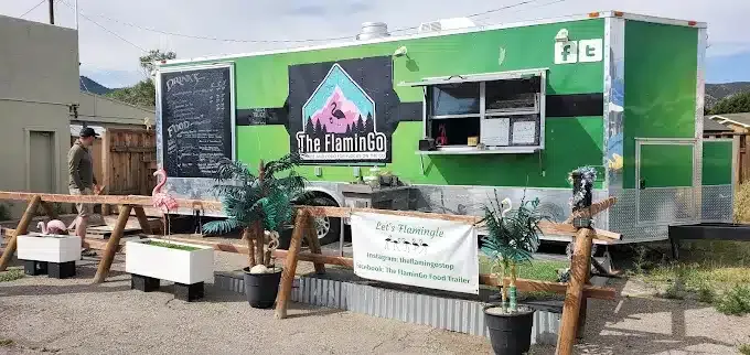 Green Flamingo food truck with outdoor seating