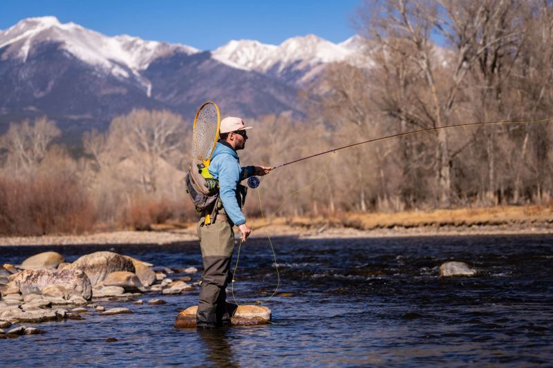 Man fly fishing in mountain river