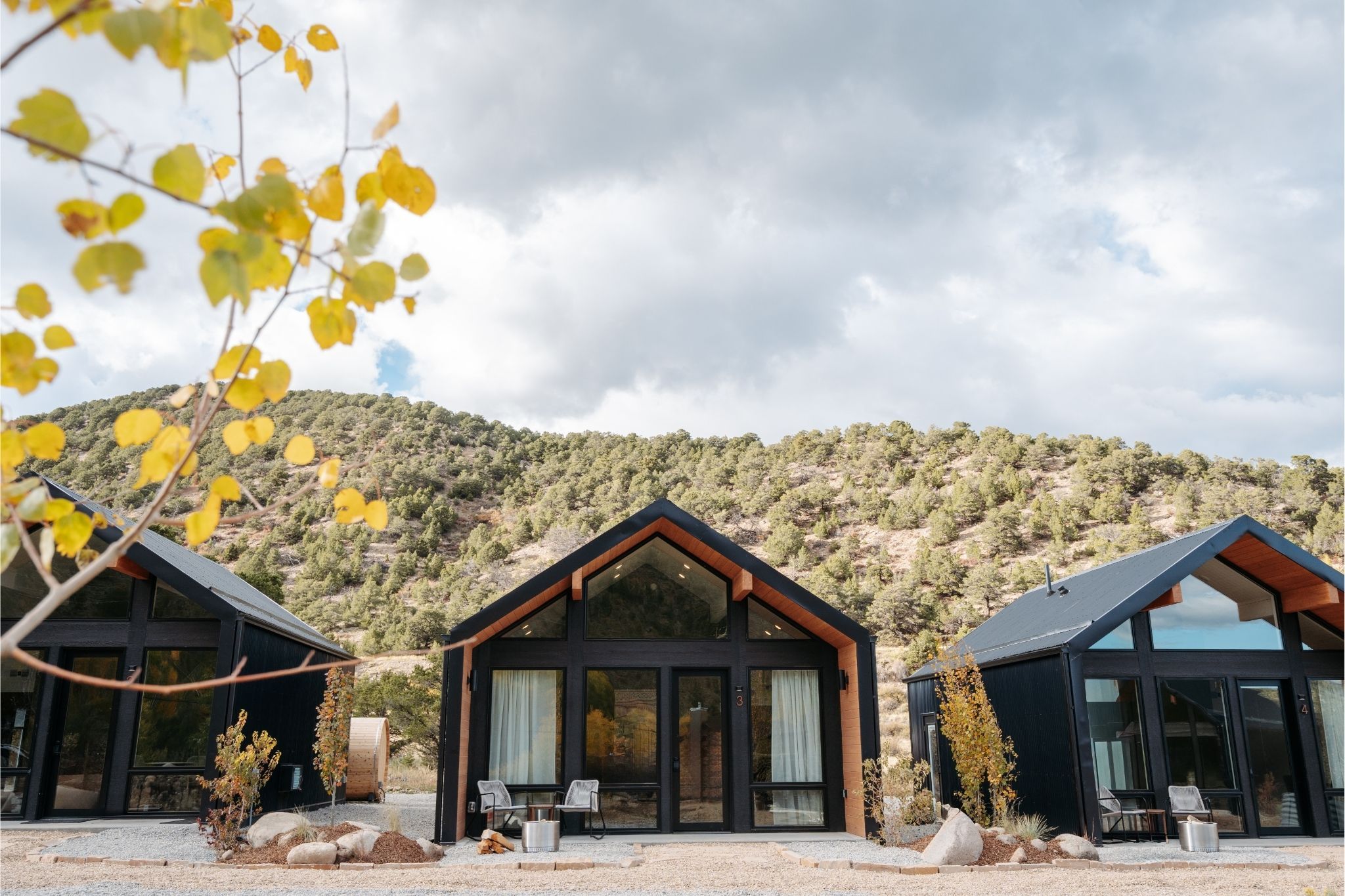 Modern black cabins in mountainous autumn landscape