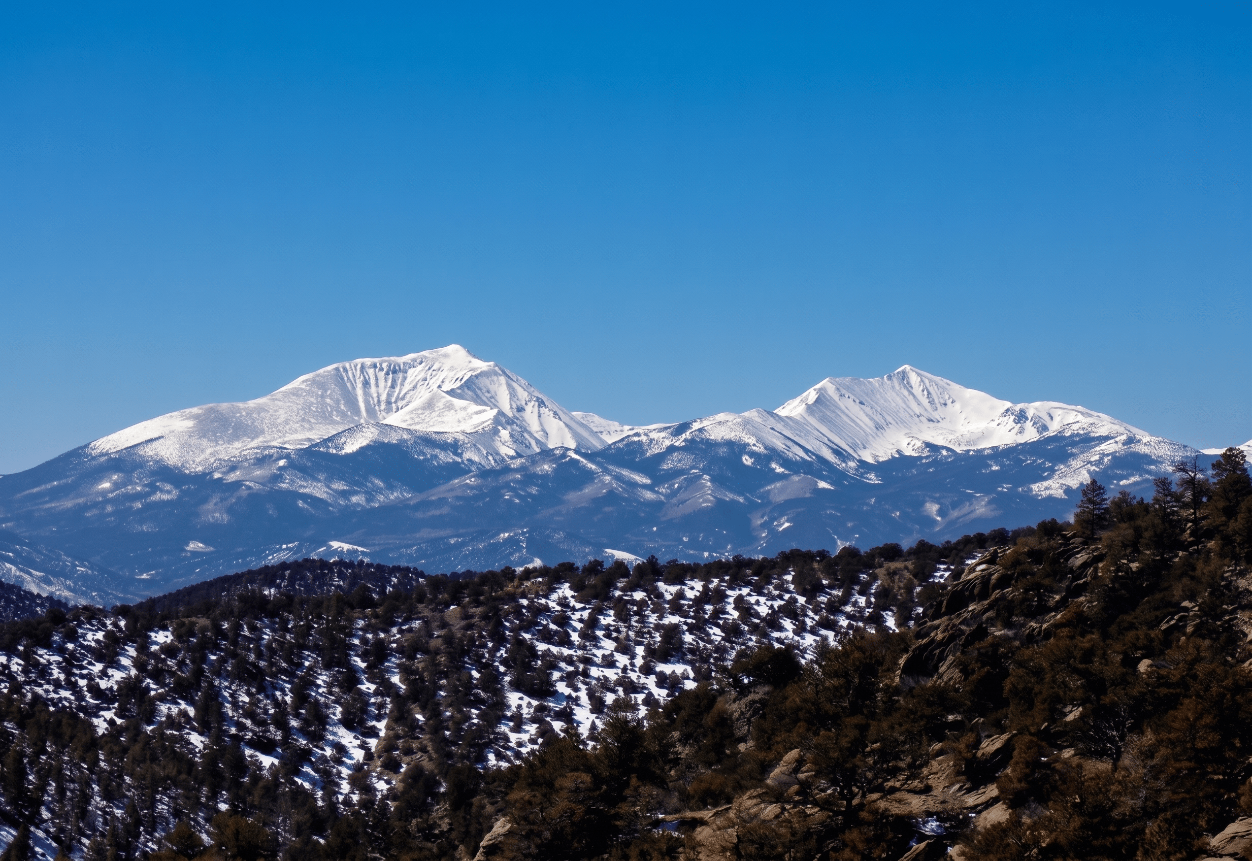 Snow-capped mountain range under clear blue sky