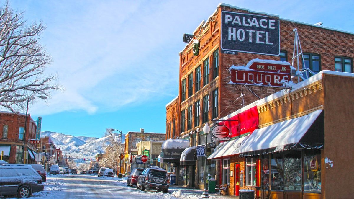 Snowy small-town street with Palace Hotel sign