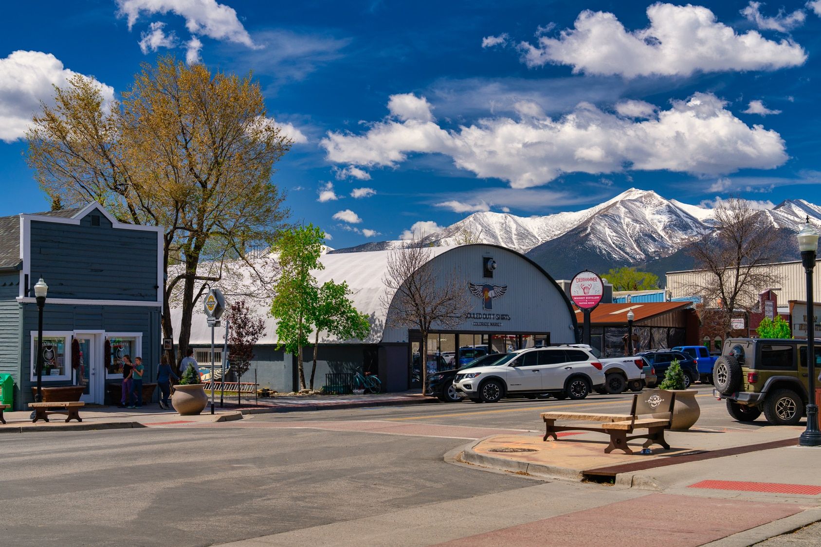 Small-town main street with snowy mountain backdrop