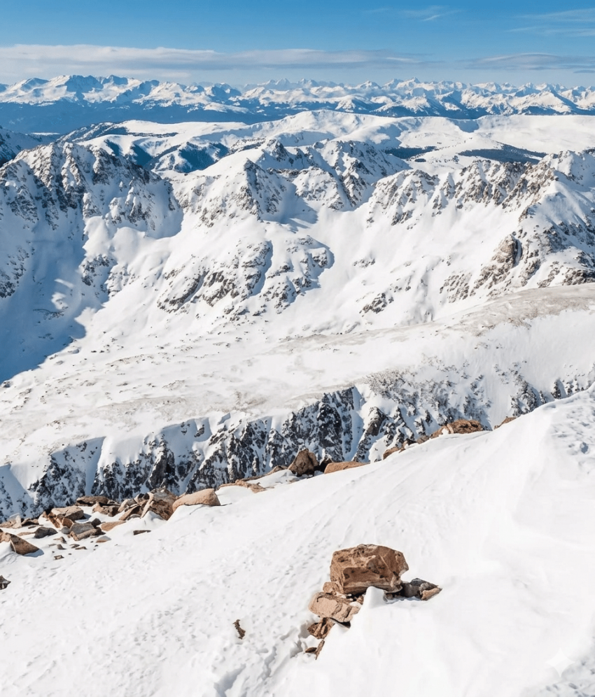 Hiker standing on top of a mountain enjoying the view in Buena Vista and Salida, CO