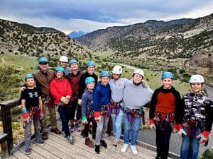 Group wearing helmets and harnesses in mountain valley