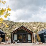 Modern black cabins in mountainous autumn landscape