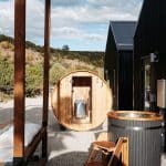 Outdoor barrel sauna and hot tub by cabin