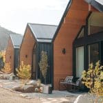 Modern wood cabins with metal roofs in mountains