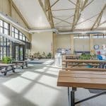 Bright community center lobby with picnic tables