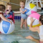 Children playing with beach balls in indoor pool