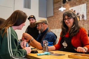 People making jewelry at hands-on workshop