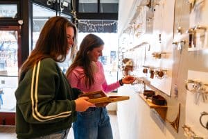 Two women browsing jewelry in boutique shop